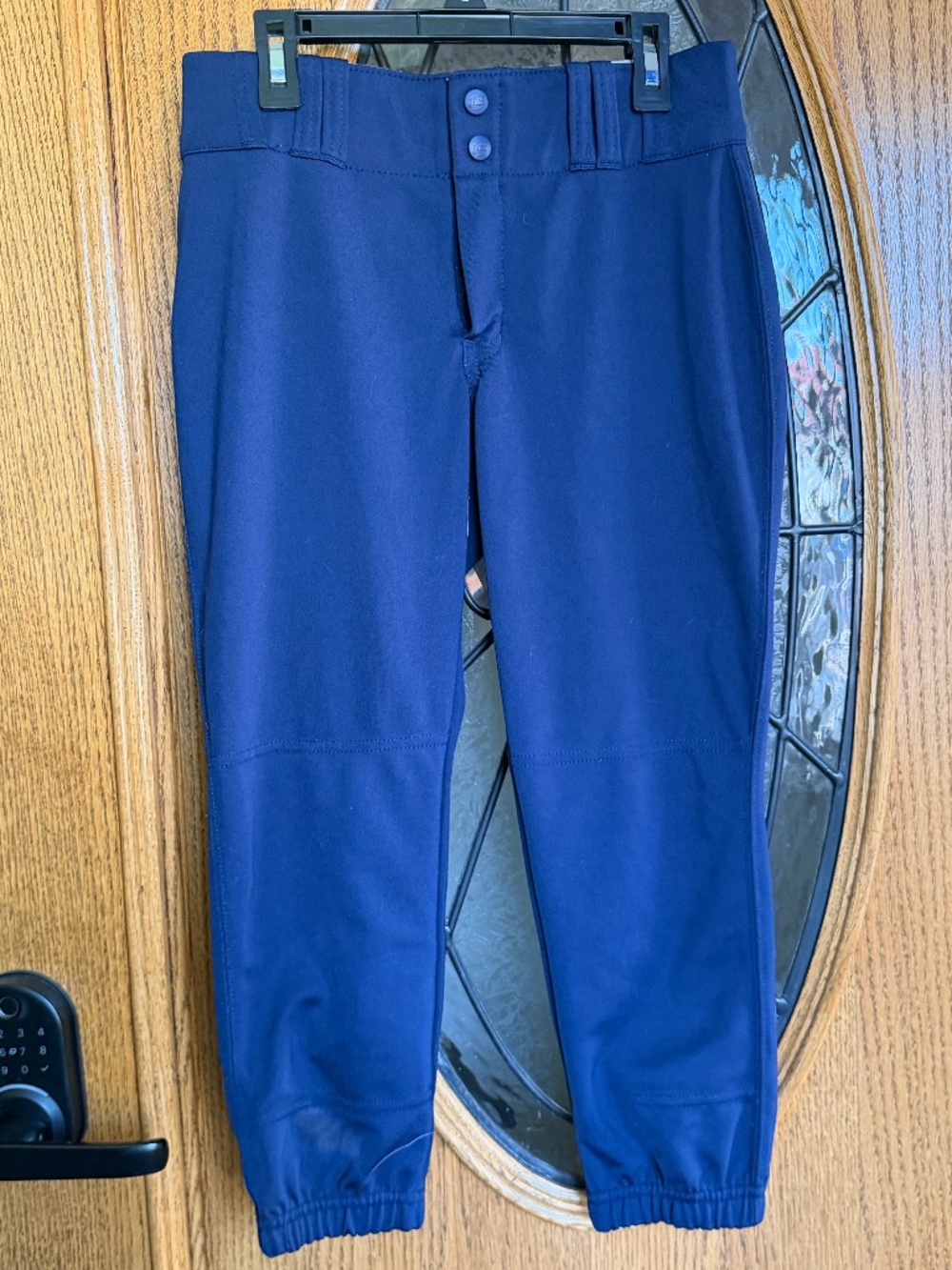 Blue softball pants with adjustable waistband and button fly